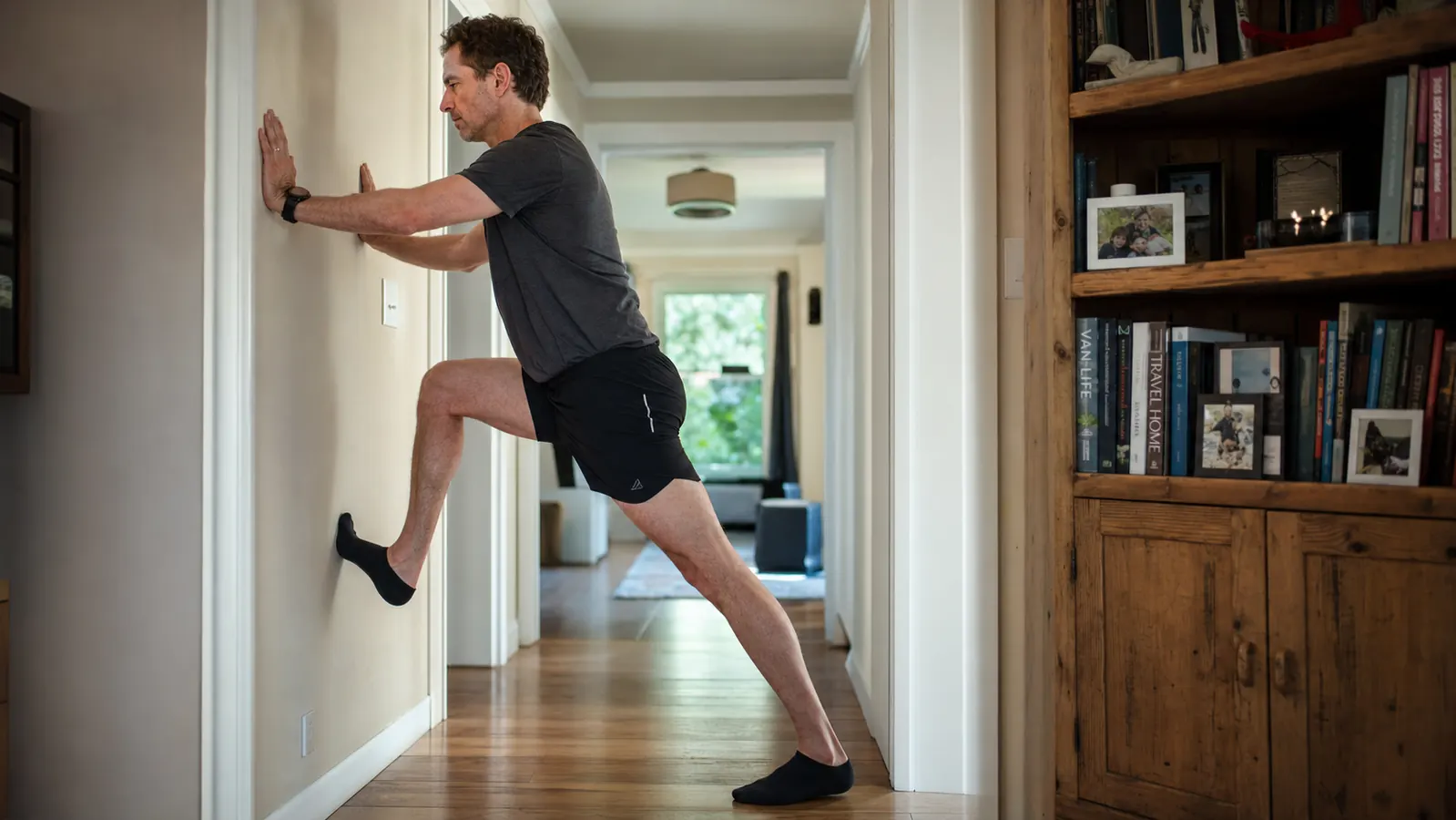 Man and his running buddy talking at a kitchen table with coffee mugs